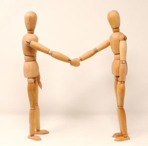woodden figure resembling negotiating